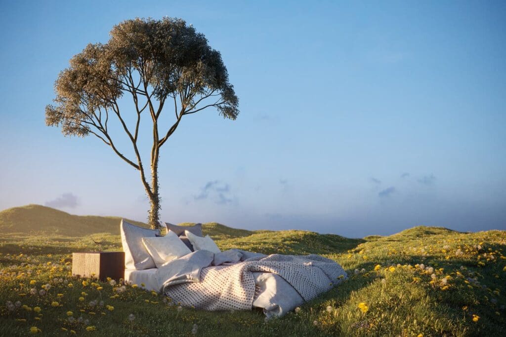 A blue sky landscape with a comfy bed under a tree